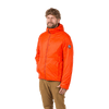 A bearded man with curly hair wears the M's Barrows Jacket by Big Agnes in orange, made from recycled Pinneco, with a circular sleeve patch and tan pants, standing against a plain white background.