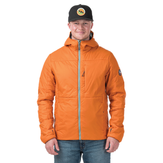Man standing in burnt orange jacket with light green accents