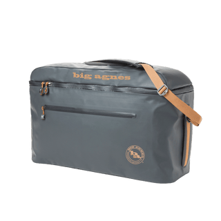 The Big Agnes Big Joe Gear Duffel is a gray heavy-duty bag with tan accents, a top handle, adjustable shoulder strap, front zipper pocket, and "big agnes" printed in tan on top.