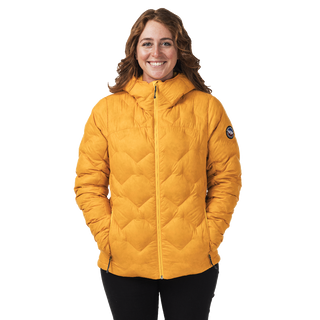 Person wearing a mustard yellow quilted jacket on a white background