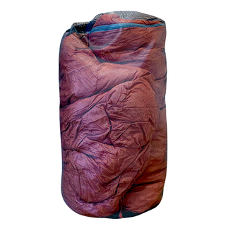 A Big Agnes Sleeping Bag Mesh Storage Sack filled with wrinkled red fabric stands upright against a plain white background.