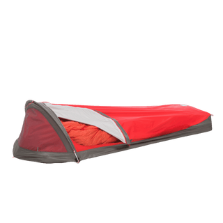 A red and gray Big Agnes Three Wire Hooped Bivy sits with its side partly open, displaying an orange sleeping bag inside. The low-profile, one-person bivy offers four-season protection and is shown against a plain white background.